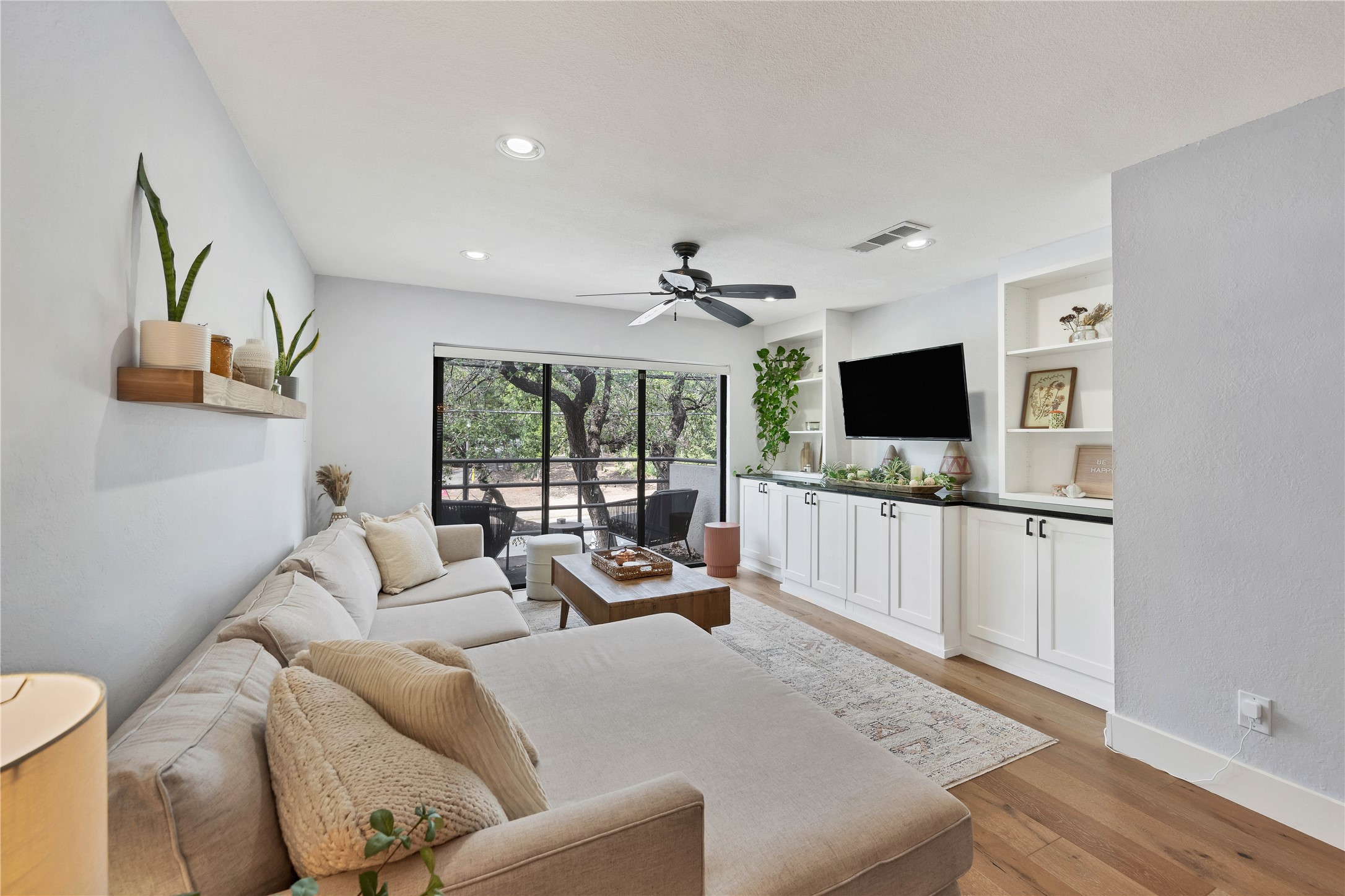 2605 Enfield Road, Unit 221 Austin, TX 78703 - Photo 29 of 30 The downstairs living space offers a great flow and open floor plan, with built-ins and a balcony.