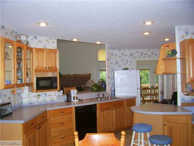 624 Wiles Ridge Road Hays, NC 28635 - Photo 3 of 16 Kitchen. Every womens dream lots of custom cabinet complimented with walk in pantry, gas range/stove, refrigerator, dishwasher, microwave, recessed lighting, opening to LR is a bar area, desk area. Open to breakfast nook & neighbors DR, LR, Entry, & Laundry.