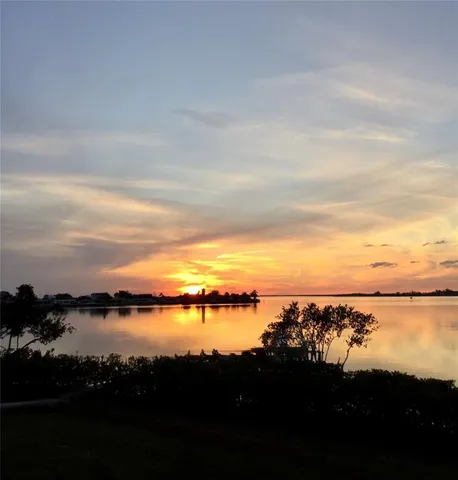 a view of lake with sunset