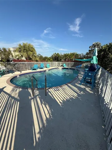 a view of a swimming pool with a lounge chairs