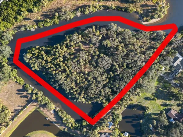 an aerial view of a house with a lake view