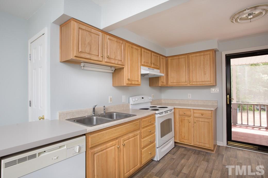 801 Sunny Lane Raleigh, NC 27603 - Photo 8 of 25 a kitchen with stainless steel appliances granite countertop a sink a stove and cabinets