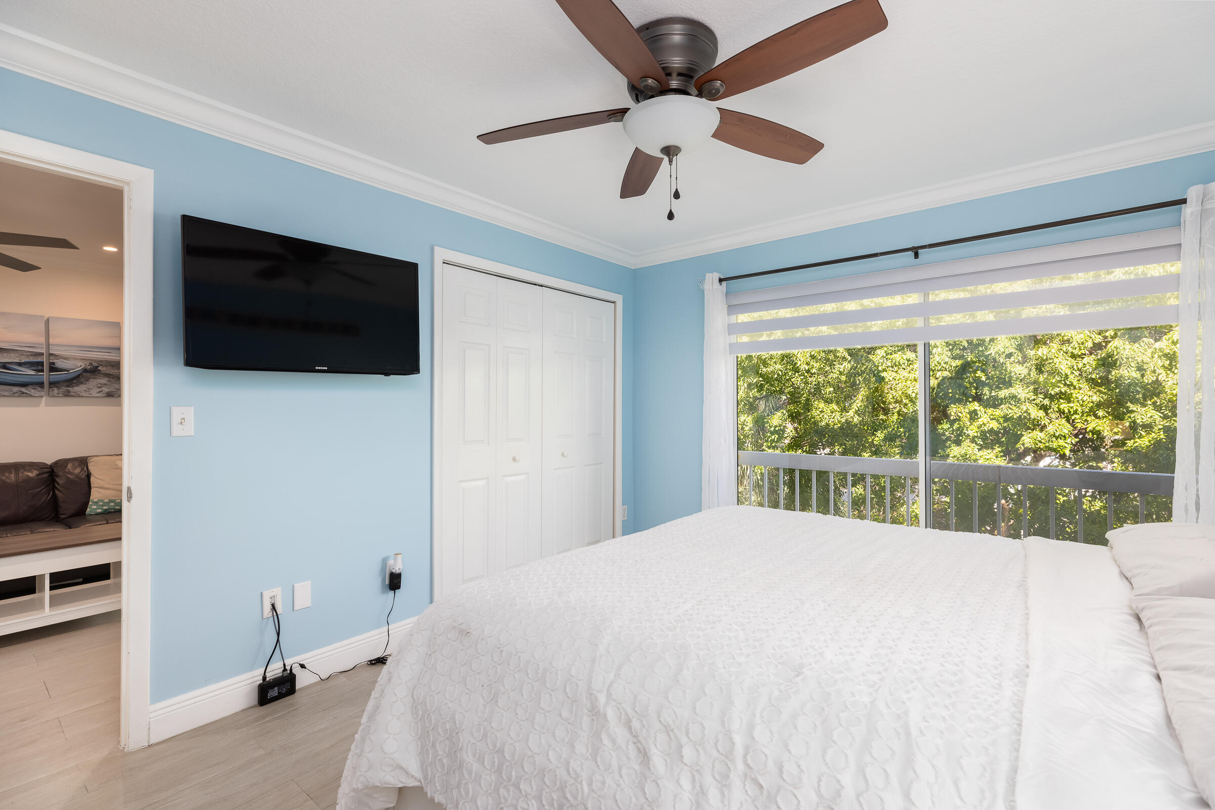 98222 Windward Avenue Key Largo, FL 33037 - Photo 18 of 41 a bedroom with a large bed and a flat screen tv