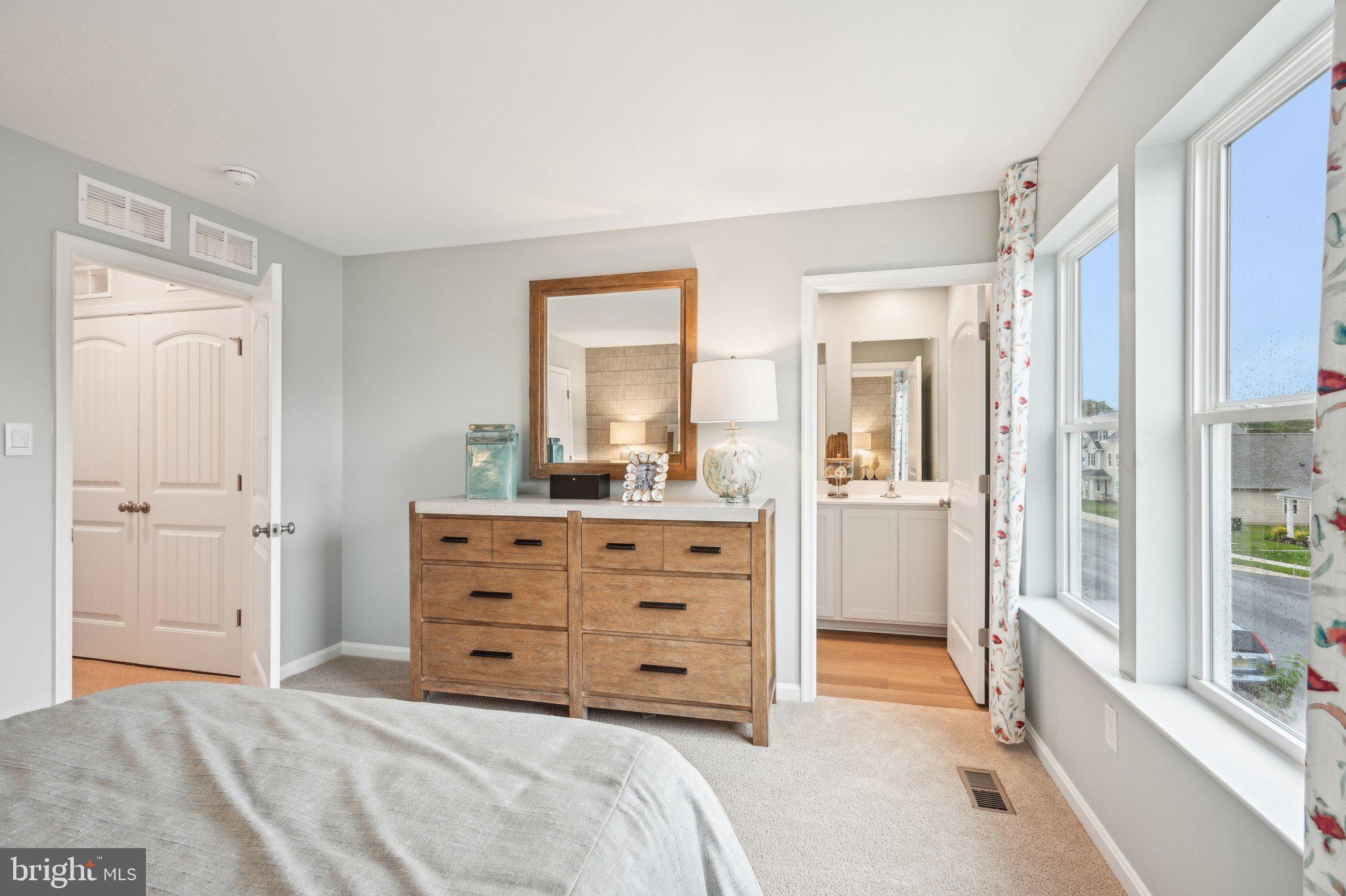 505 Colette Street Ellendale, DE 19941 - Photo 19 of 30 a room with a bed and a mirror