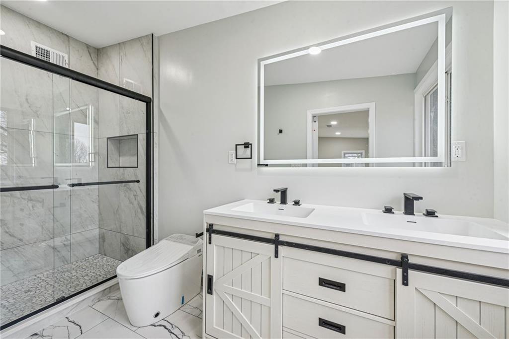 4531 Ridgeview Drive Greensburg, PA 15601 - Photo 22 of 41 a bathroom with a sink toilet a mirror and shower