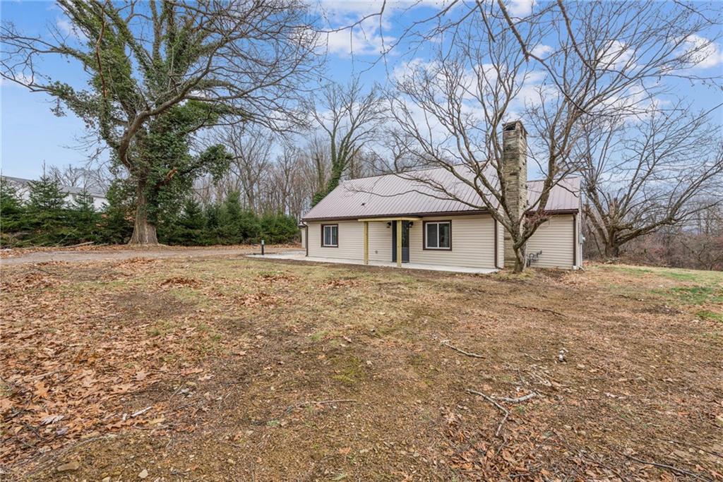 4531 Ridgeview Drive Greensburg, PA 15601 - Photo 35 of 41 a backyard of a house with large trees and barbeque oven
