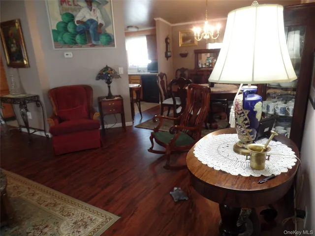 a dining room with furniture window and wooden floor