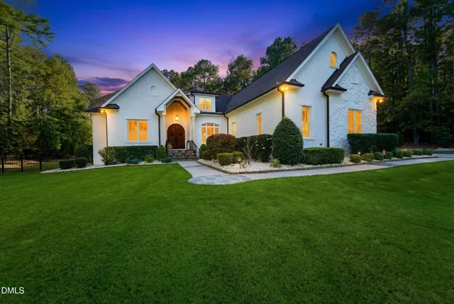 a front view of a house with a yard table and chairs
