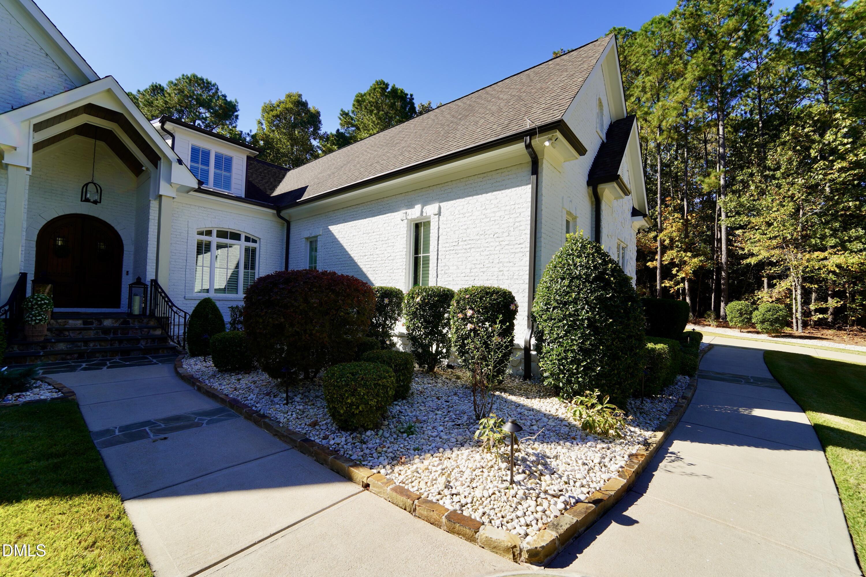 2604 Homestead Forest Road Zebulon, NC 27597 - Photo 9 of 101 a front view of a house with garden