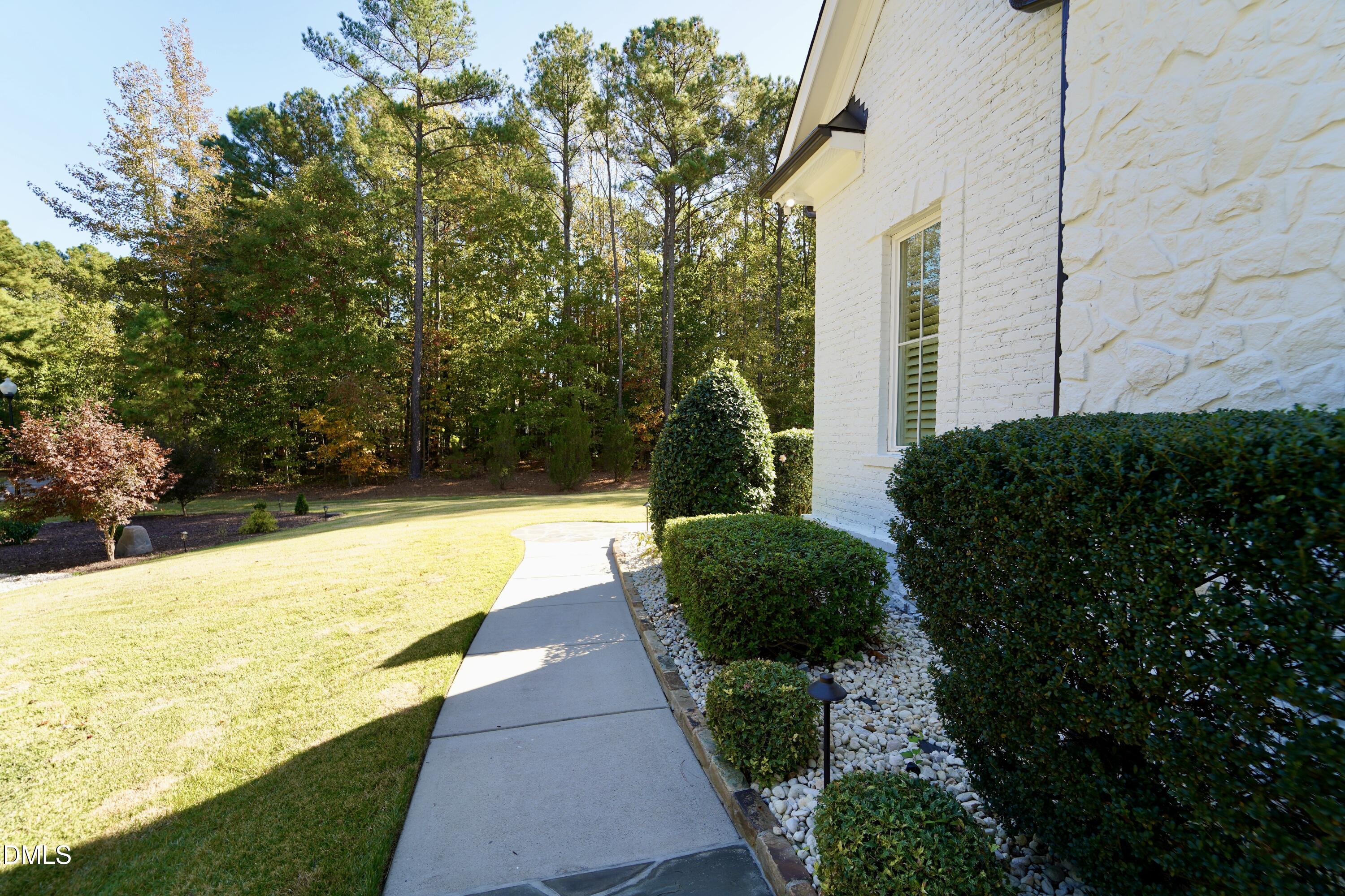 2604 Homestead Forest Road Zebulon, NC 27597 - Photo 10 of 101 a view of swimming pool with lawn chairs under an umbrella