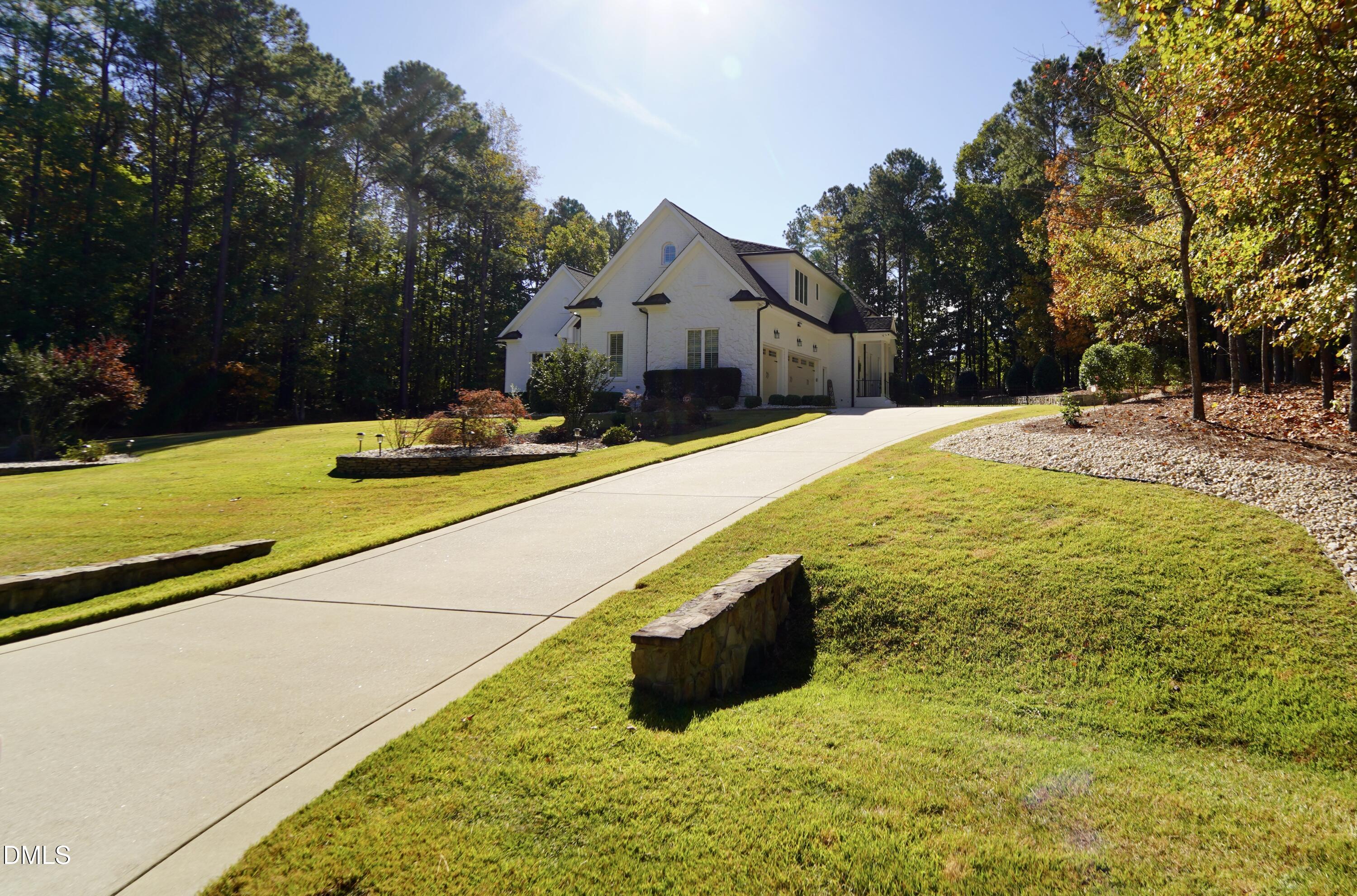 2604 Homestead Forest Road Zebulon, NC 27597 - Photo 17 of 101 a swimming pool with some trees in the background