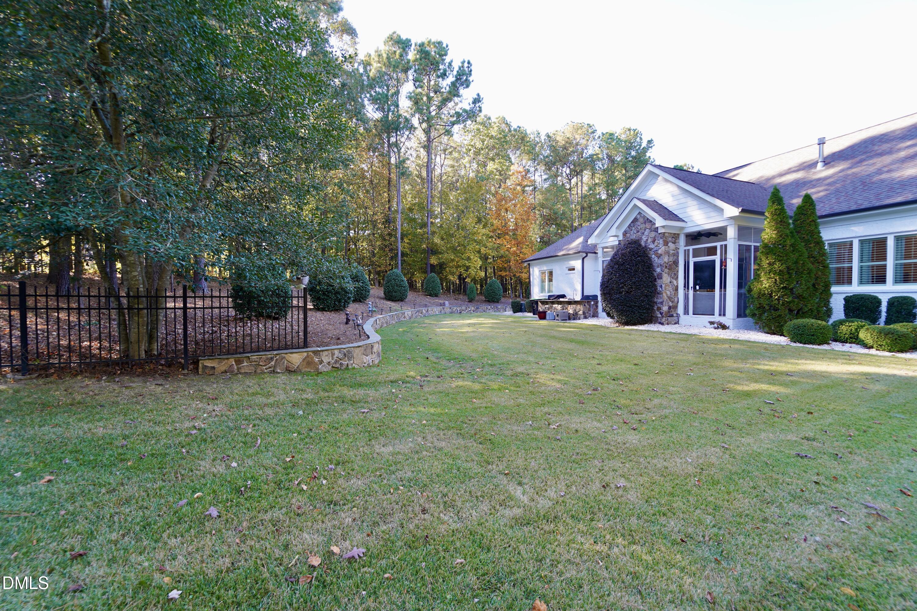 2604 Homestead Forest Road Zebulon, NC 27597 - Photo 26 of 101 a view of a house with a yard and trees