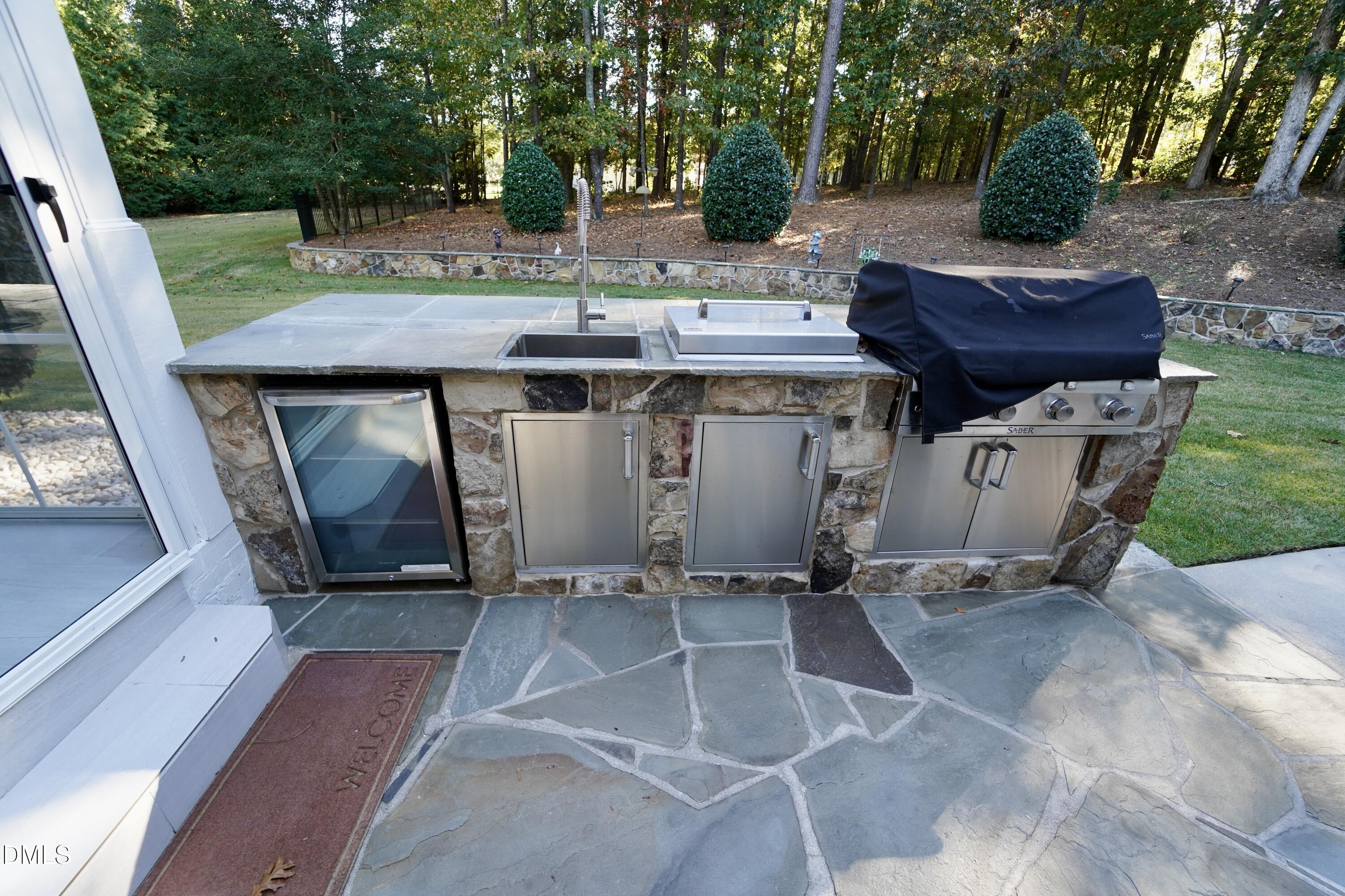2604 Homestead Forest Road Zebulon, NC 27597 - Photo 27 of 101 a view of a chairs and table in the backyard