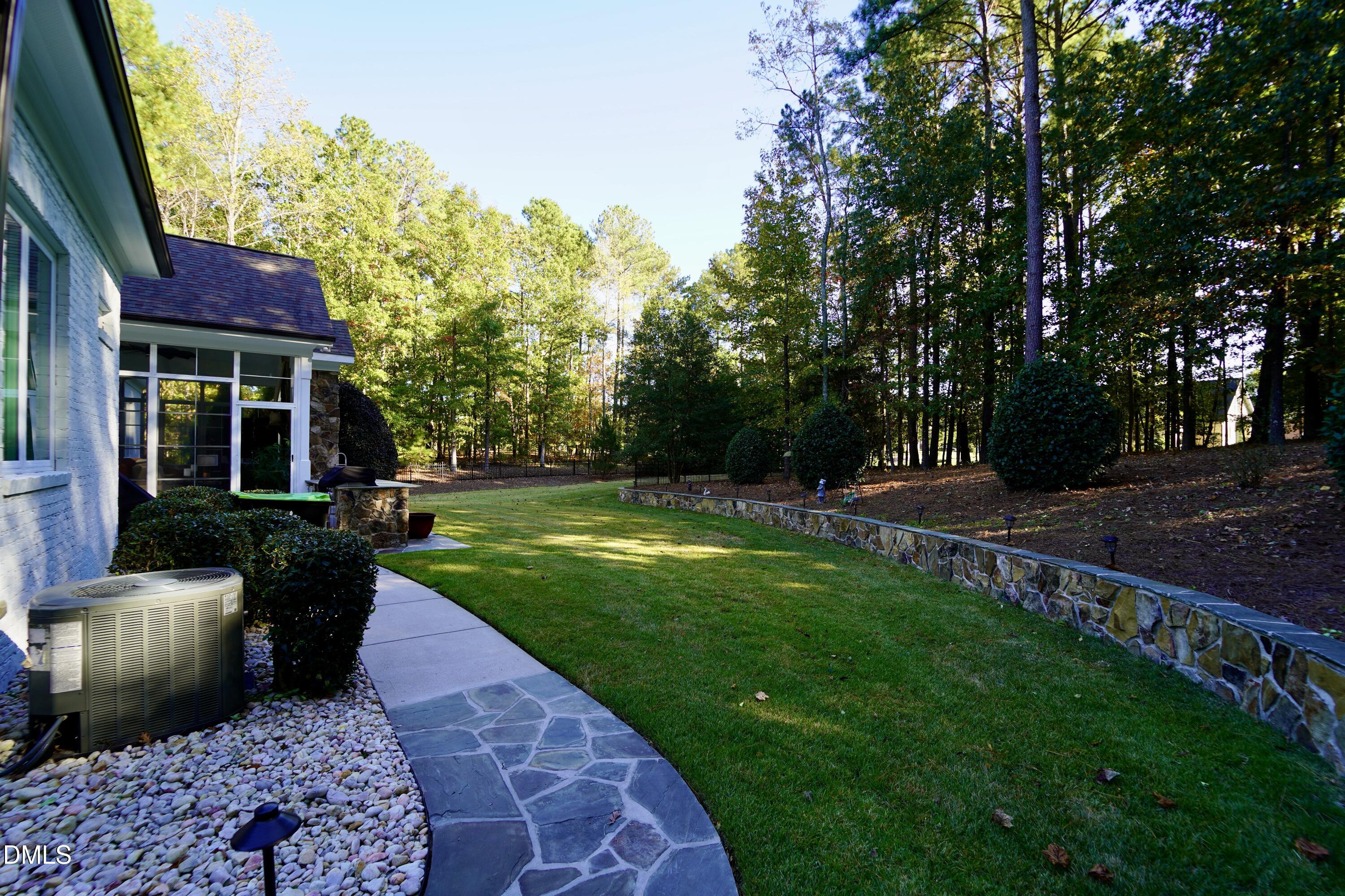 2604 Homestead Forest Road Zebulon, NC 27597 - Photo 31 of 101 a view of a house with backyard and sitting area