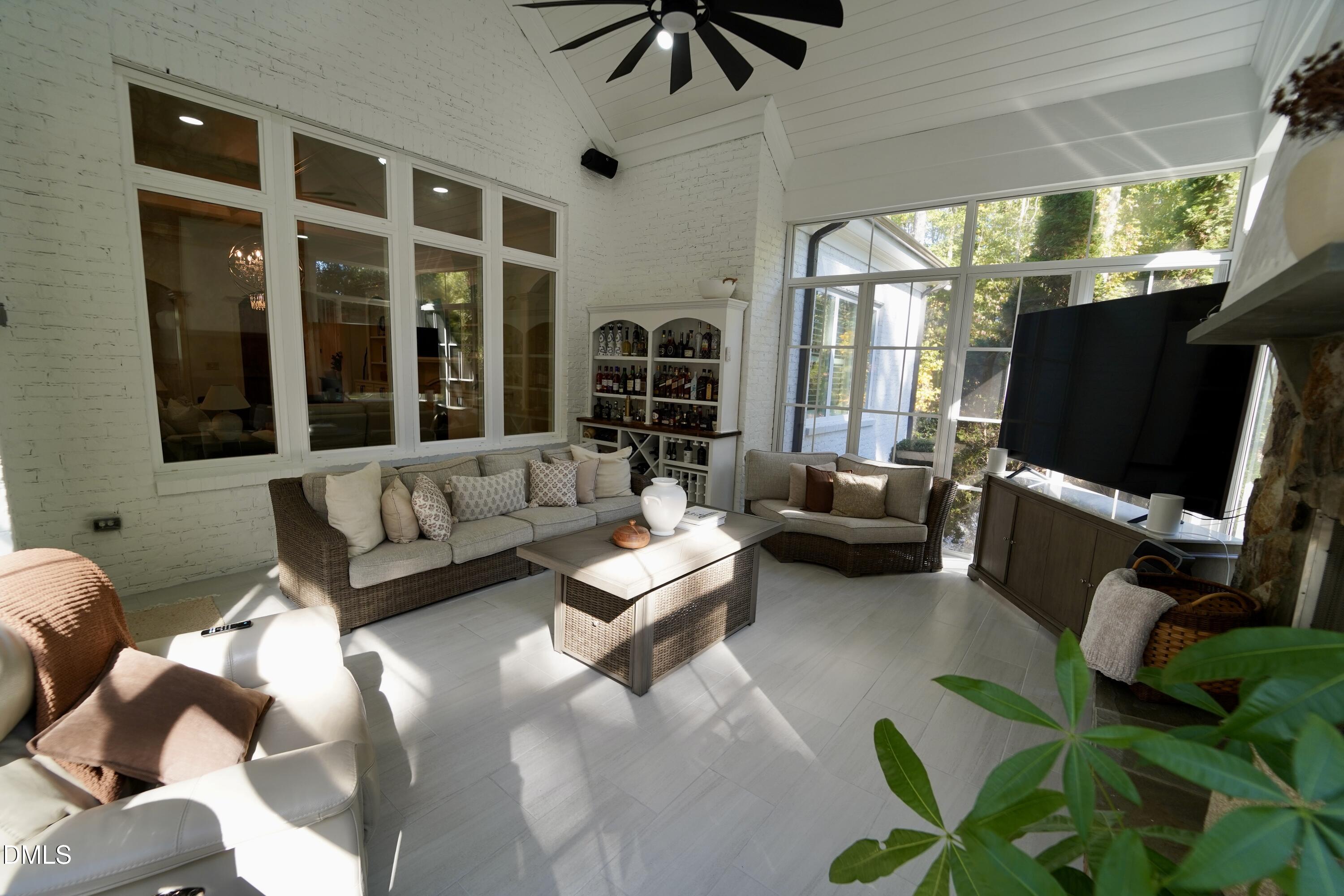 2604 Homestead Forest Road Zebulon, NC 27597 - Photo 52 of 101 a living room with furniture a flat screen tv and a large window