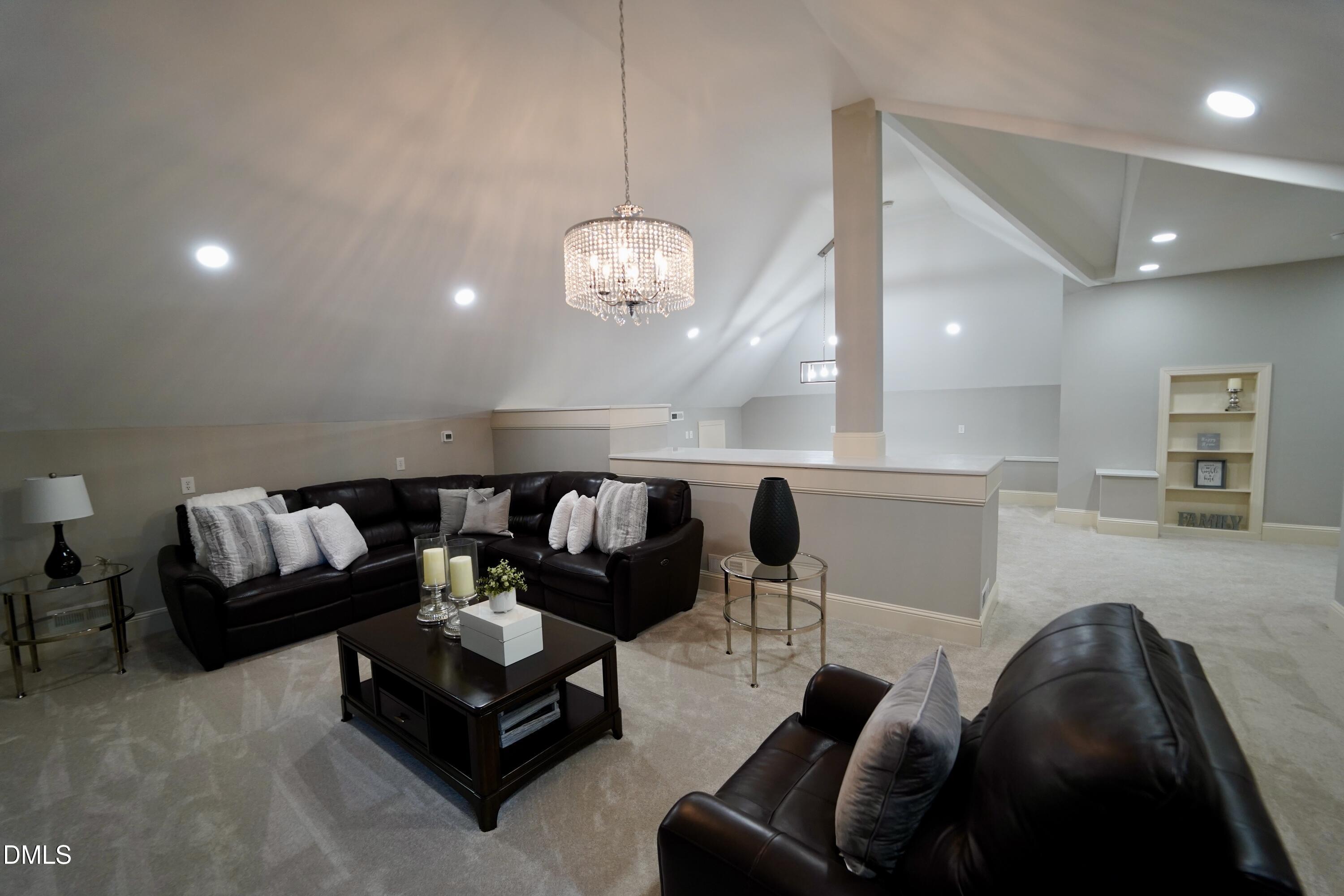 2604 Homestead Forest Road Zebulon, NC 27597 - Photo 56 of 101 a living room with furniture and a large mirror with wooden floor