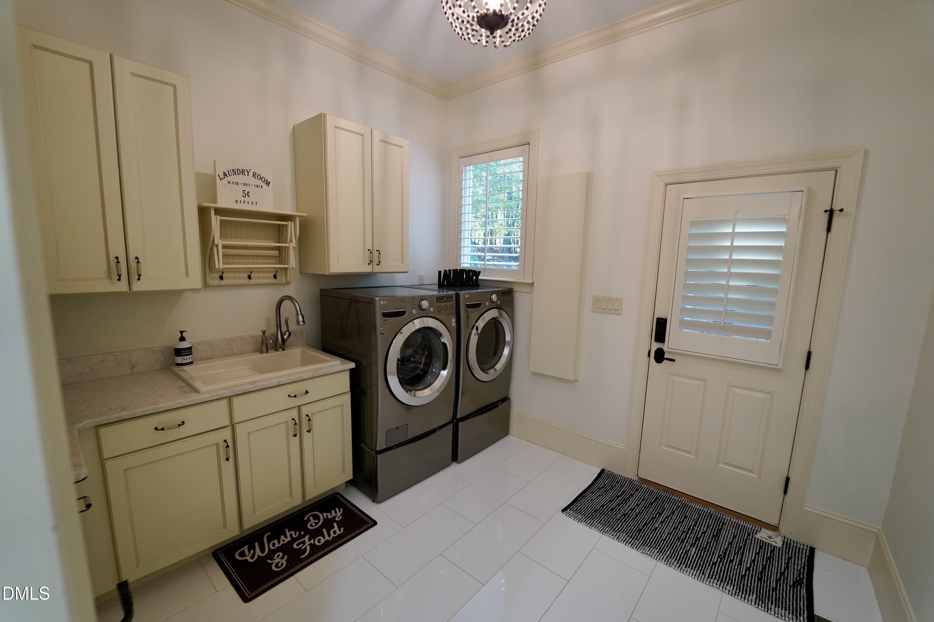 2604 Homestead Forest Road Zebulon, NC 27597 - Photo 70 of 101 a utility room with closet dryer and washer