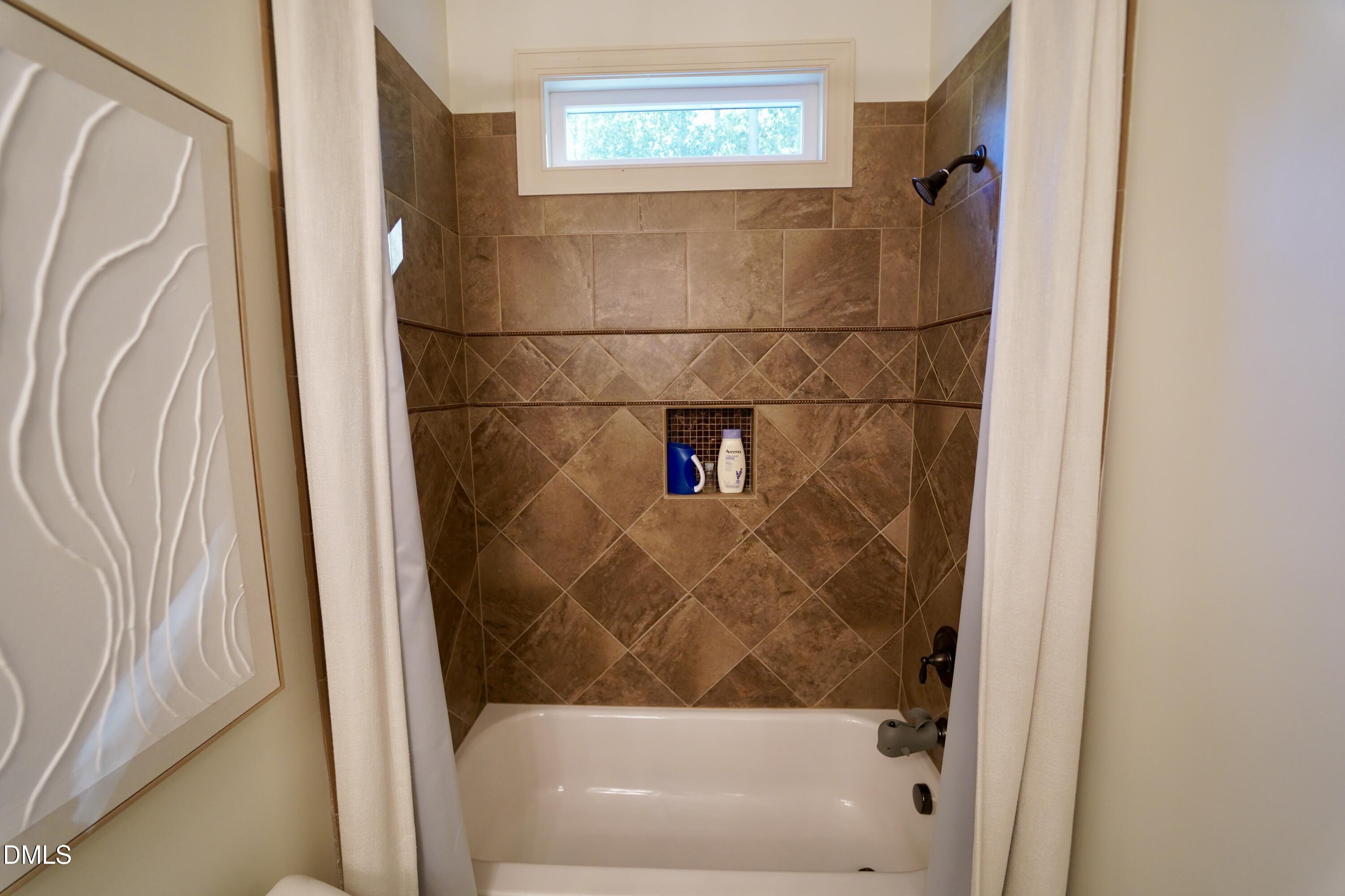 2604 Homestead Forest Road Zebulon, NC 27597 - Photo 78 of 101 a bathroom with a bathtub and a shower