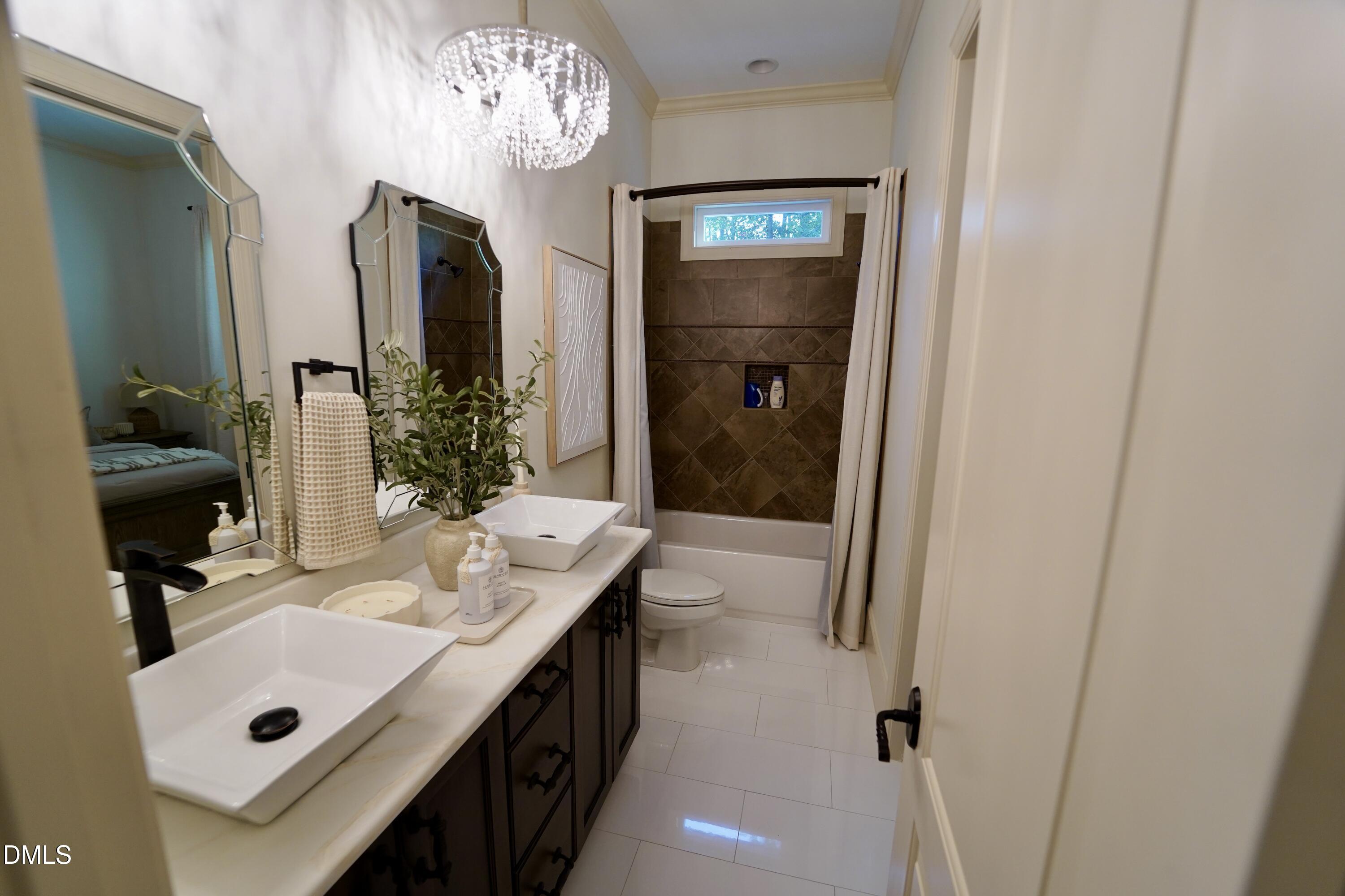 2604 Homestead Forest Road Zebulon, NC 27597 - Photo 83 of 101 a bathroom with a sink double vanity and a mirror