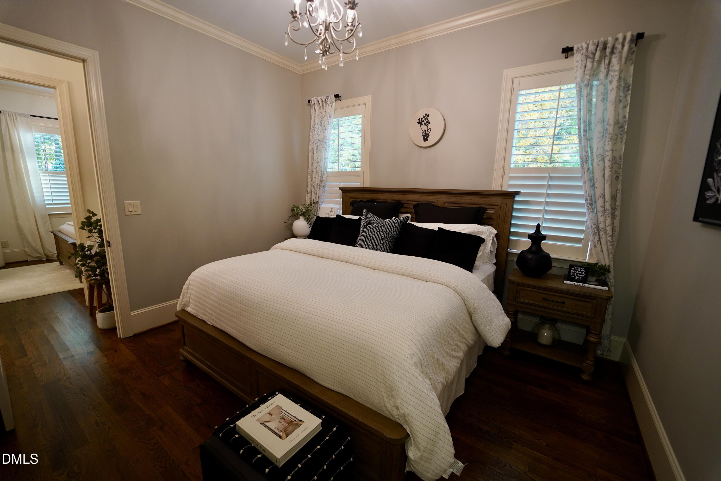2604 Homestead Forest Road Zebulon, NC 27597 - Photo 85 of 101 a bedroom with a bed and wooden floor
