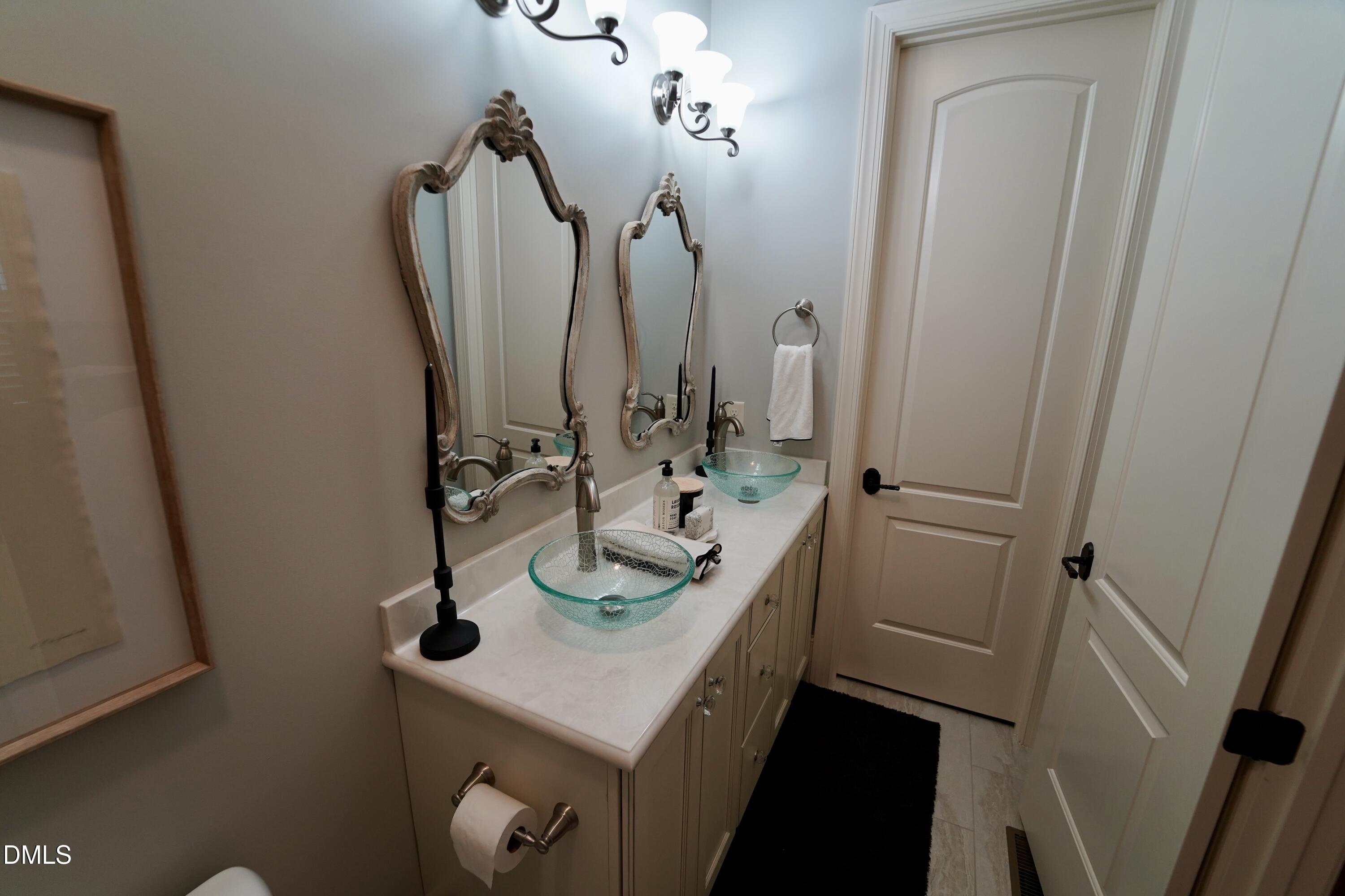 2604 Homestead Forest Road Zebulon, NC 27597 - Photo 86 of 101 a bathroom with a sink and a mirror