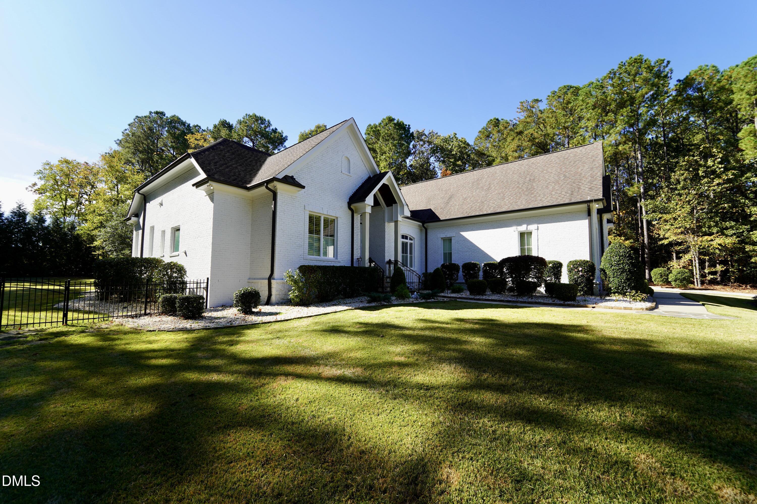 2604 Homestead Forest Road Zebulon, NC 27597 - Photo 7 of 101 a view of a house with swimming pool and a yard