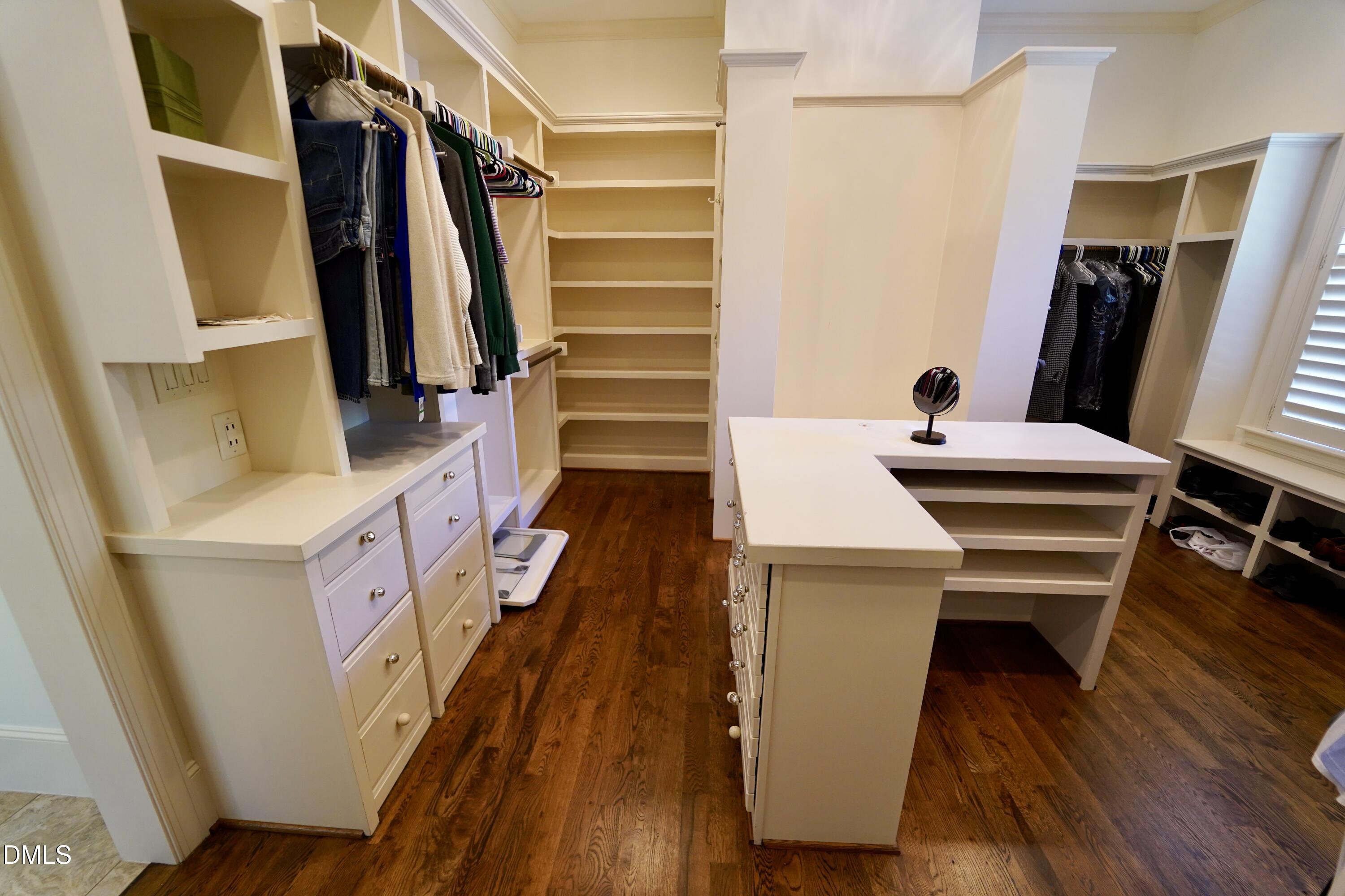 2604 Homestead Forest Road Zebulon, NC 27597 - Photo 92 of 101 a view of walk in closet with clothes and wooden floor