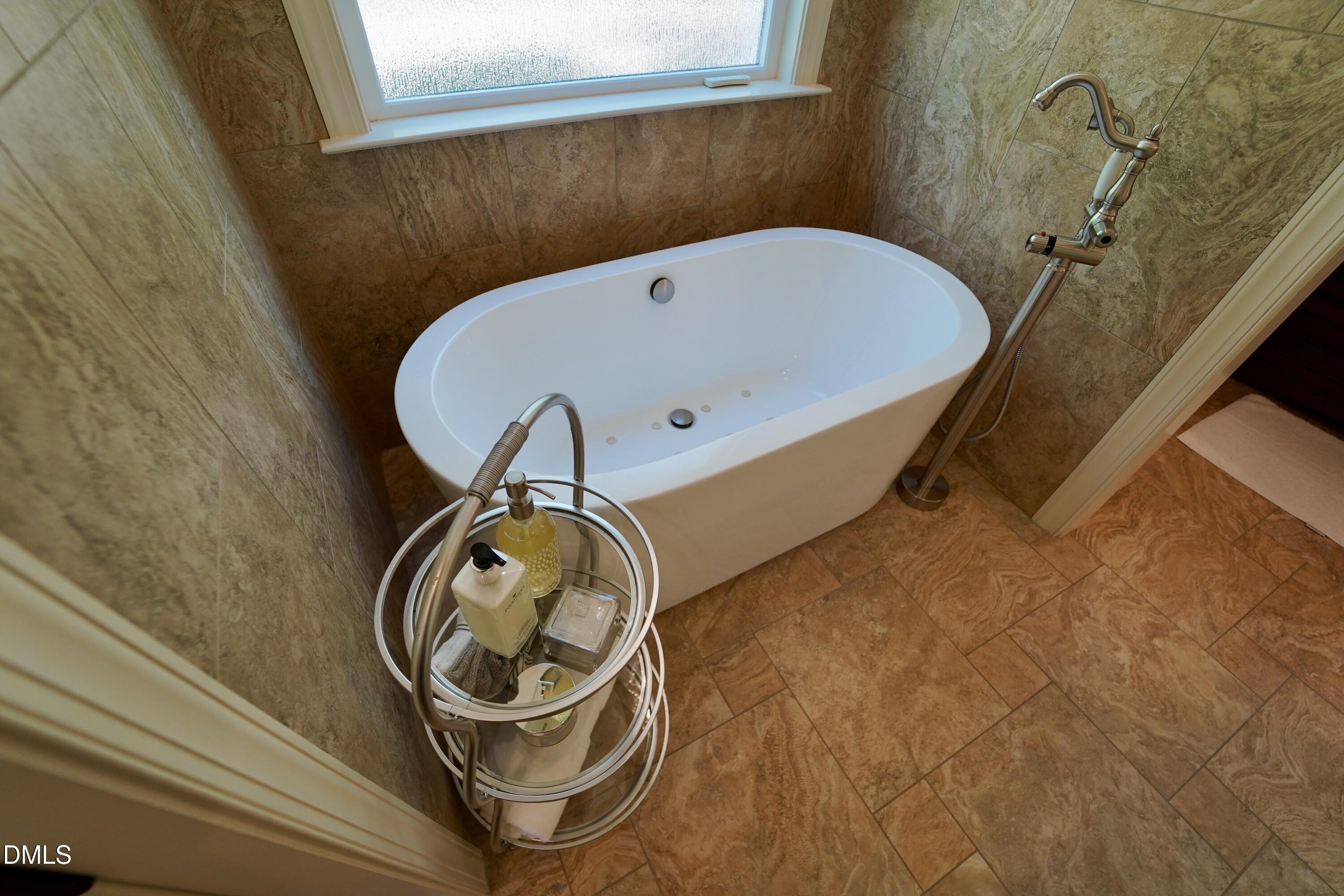 2604 Homestead Forest Road Zebulon, NC 27597 - Photo 93 of 101 a bathroom with a tub and sink