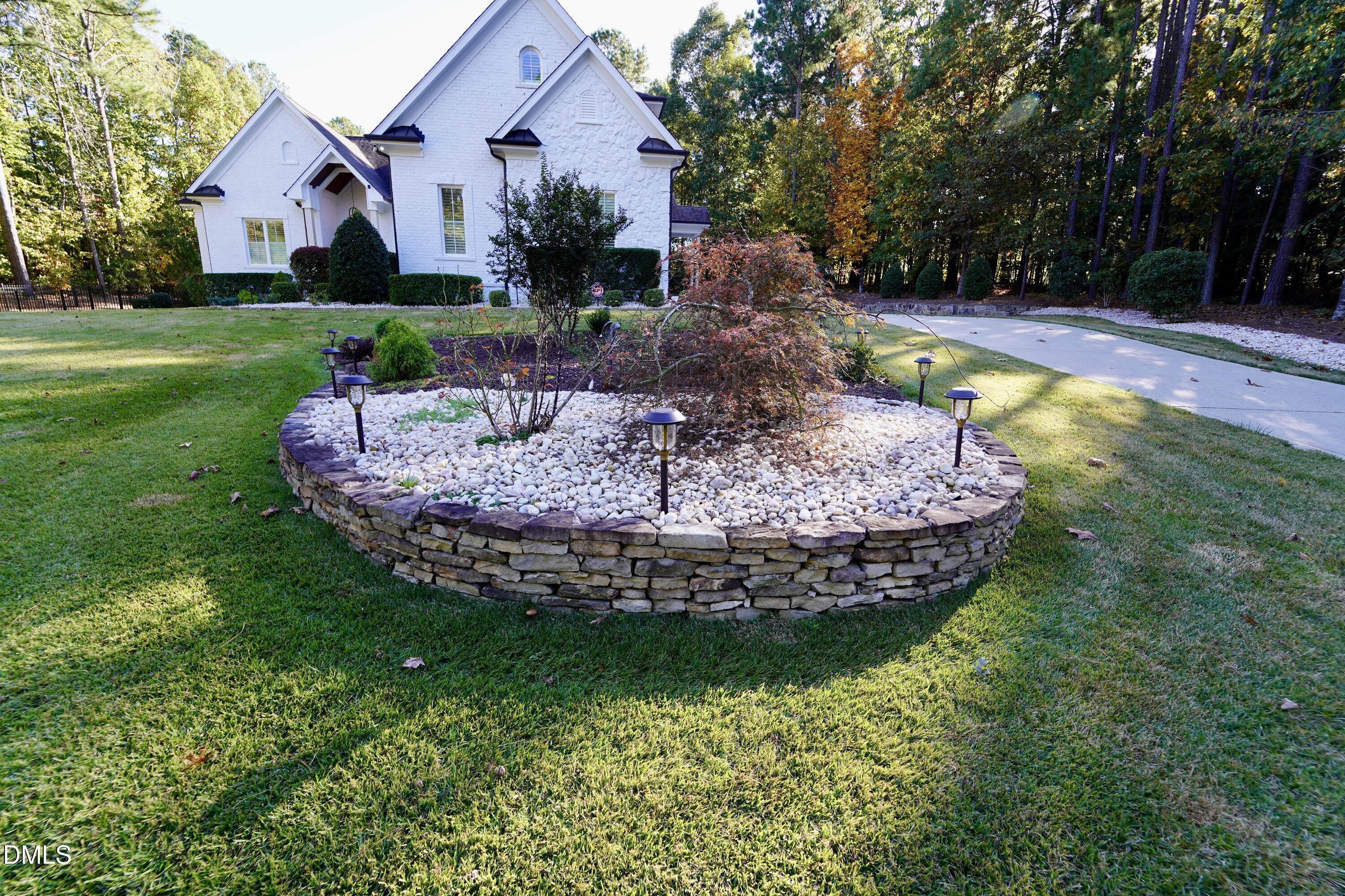 2604 Homestead Forest Road Zebulon, NC 27597 - Photo 8 of 101 a view of a house with a yard potted plants and large tree