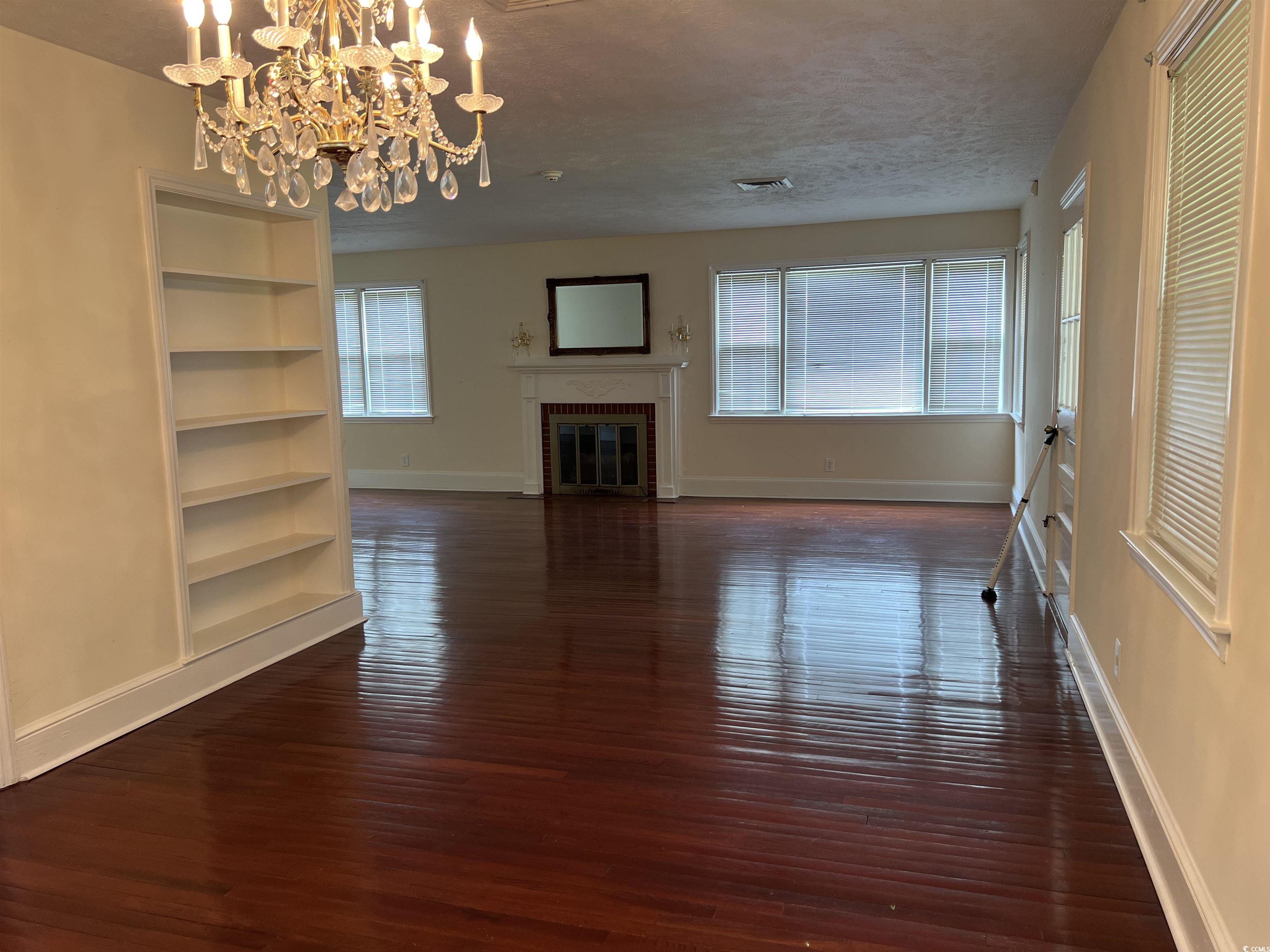880 Horry Road Conway, SC 29526 - Photo 14 of 16 Unfurnished living room with an inviting chandelie