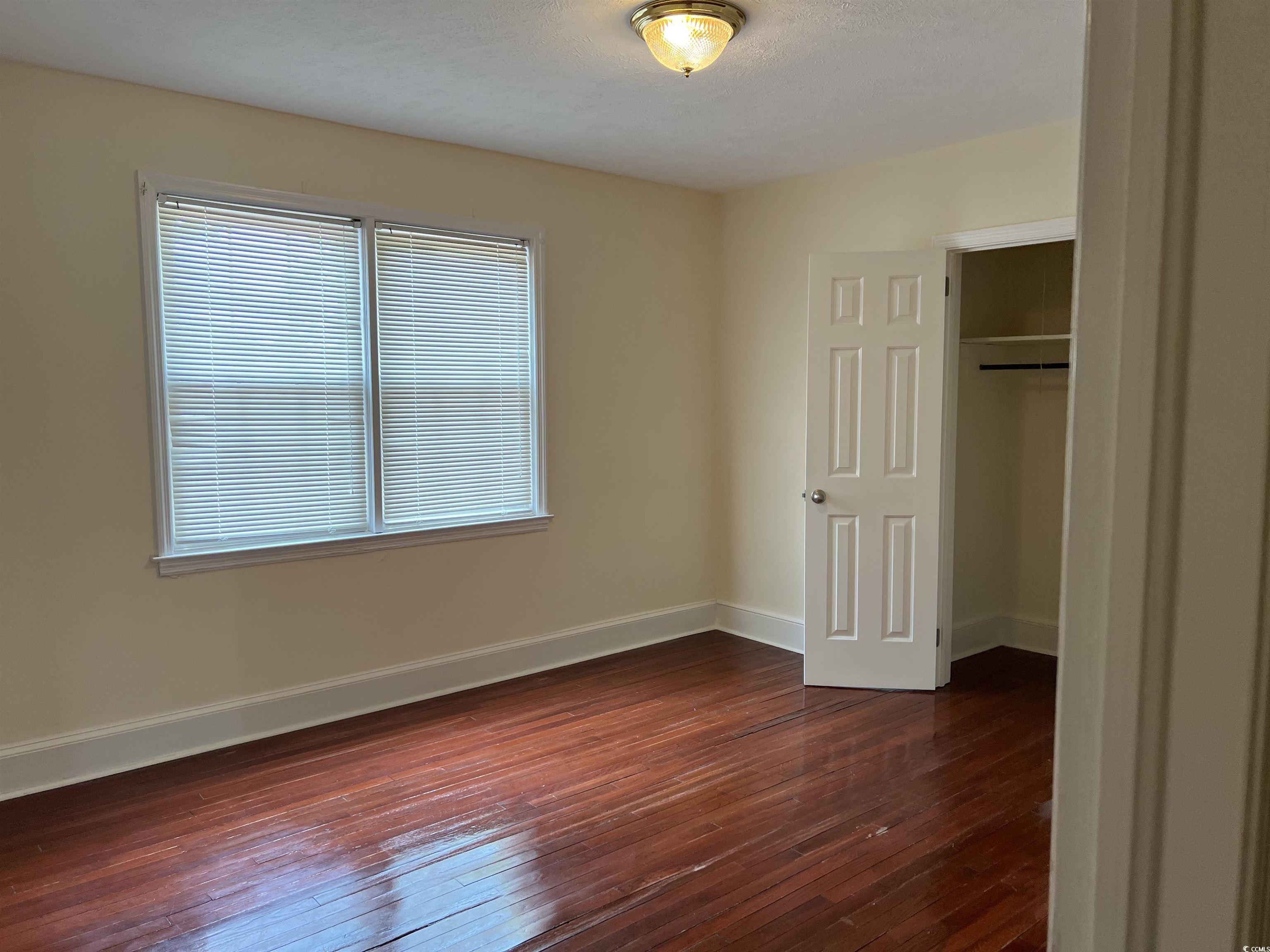 880 Horry Road Conway, SC 29526 - Photo 10 of 16 Unfurnished bedroom featuring a closet and wood-ty