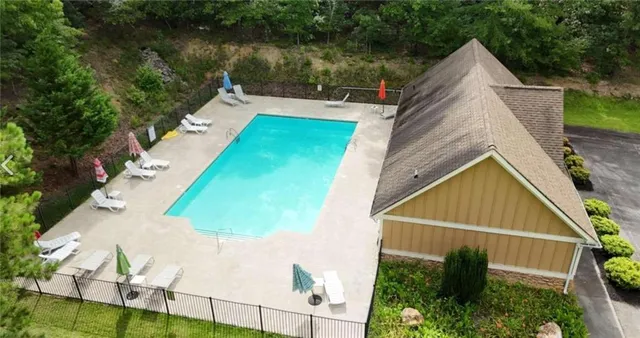 a view of a backyard with plants and lake view