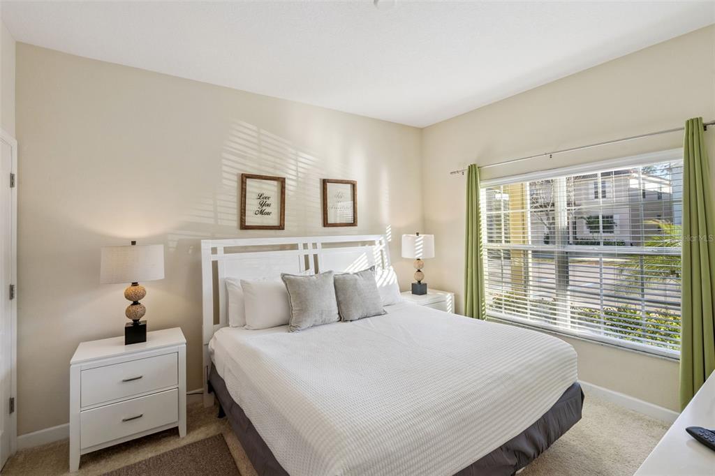 8957 Sugar Palm Road Kissimmee, FL 34747 - Photo 11 of 68 a bedroom with a large bed and a large window