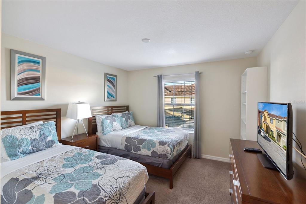 8957 Sugar Palm Road Kissimmee, FL 34747 - Photo 12 of 68 a bedroom with two beds and a window