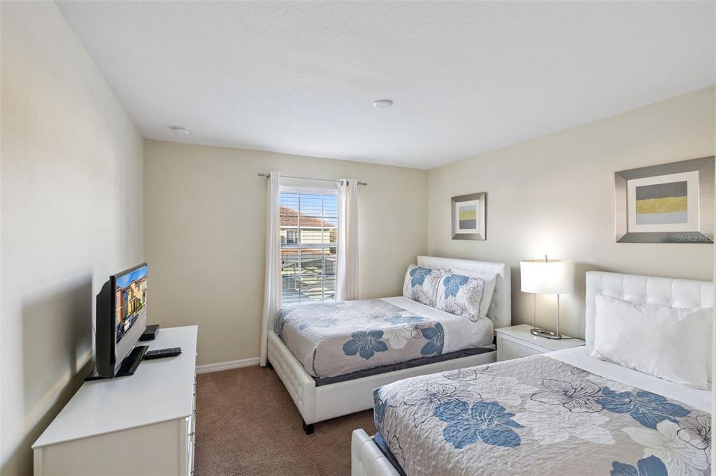 8957 Sugar Palm Road Kissimmee, FL 34747 - Photo 13 of 68 a bedroom with a bed and a couch