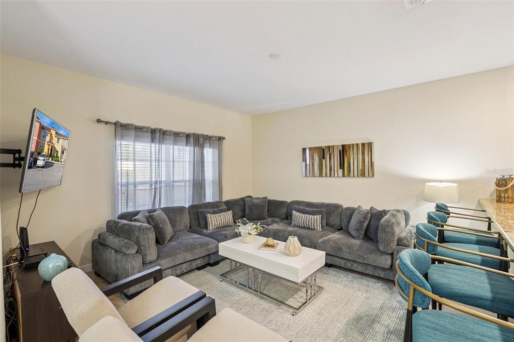 8957 Sugar Palm Road Kissimmee, FL 34747 - Photo 3 of 68 a living room with furniture and a window