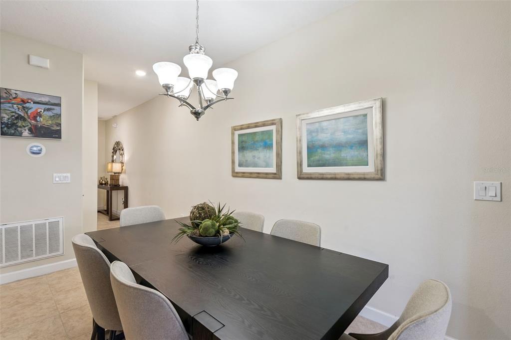 8957 Sugar Palm Road Kissimmee, FL 34747 - Photo 5 of 68 a view of a dining room with furniture and chandelier
