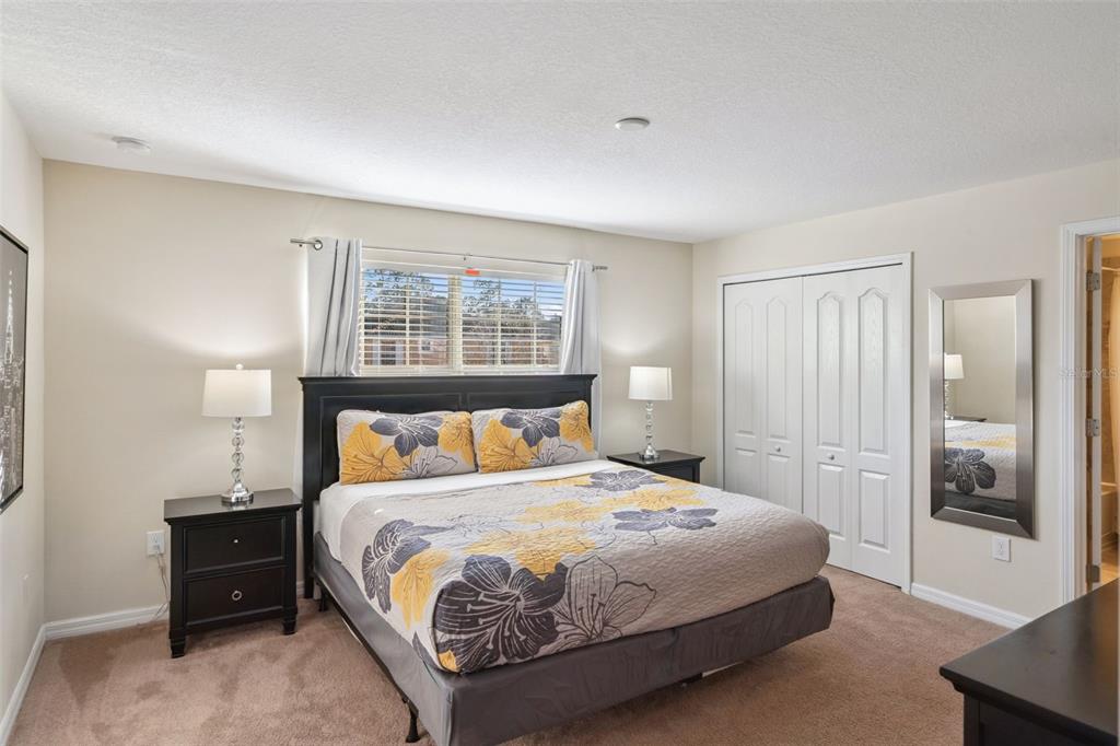 8957 Sugar Palm Road Kissimmee, FL 34747 - Photo 9 of 68 a bedroom with a large bed and a window