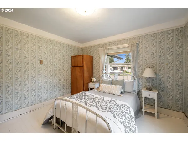 a bedroom with a bed and a chair
