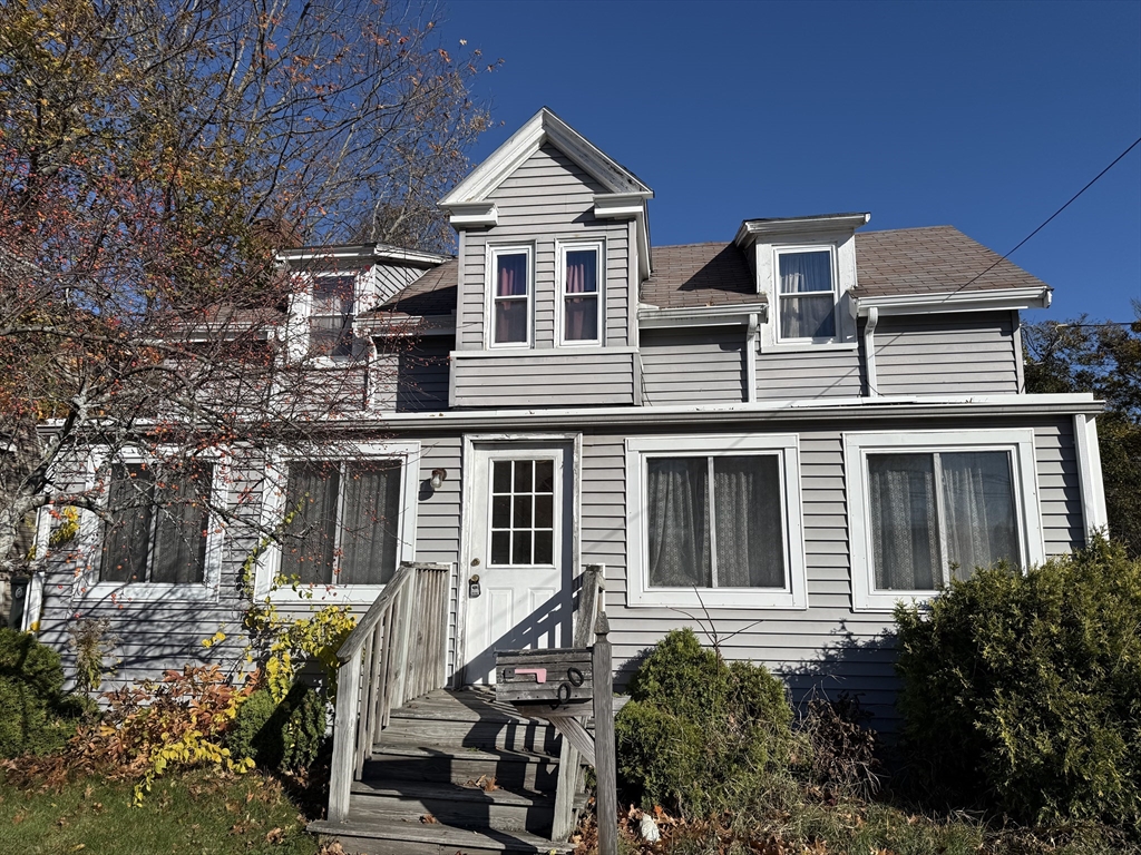a view of a big house with wooden fence and large windows