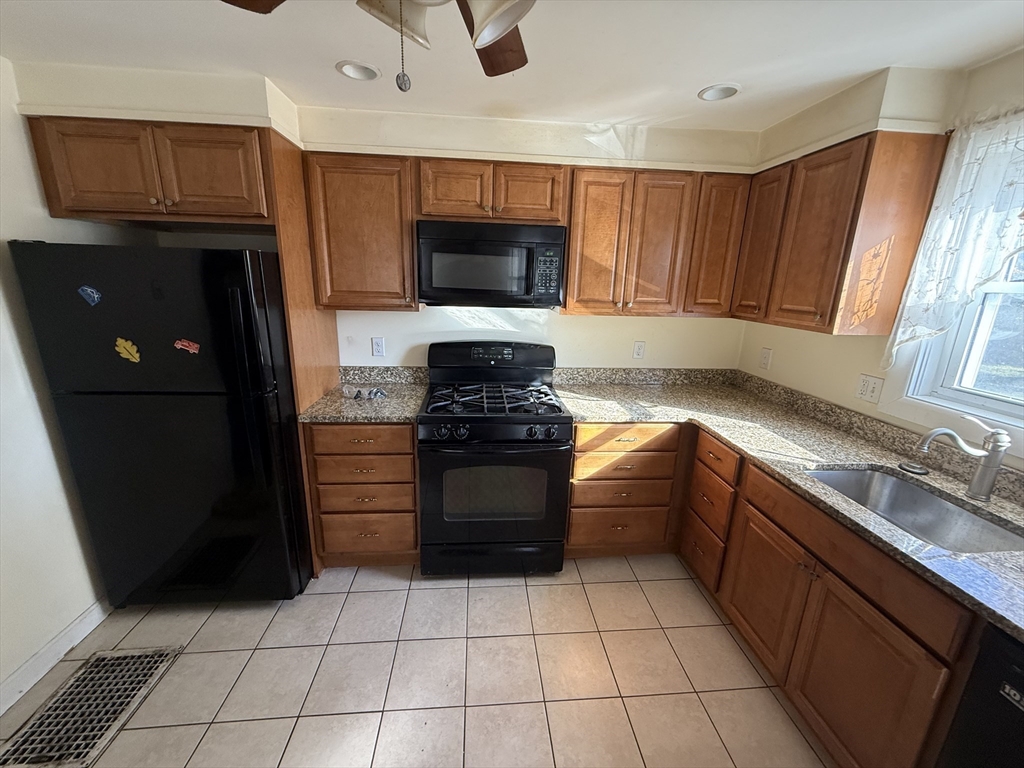 100 Poplar Street Danvers, MA 01923 - Photo 12 of 24 a kitchen with a refrigerator sink and stove