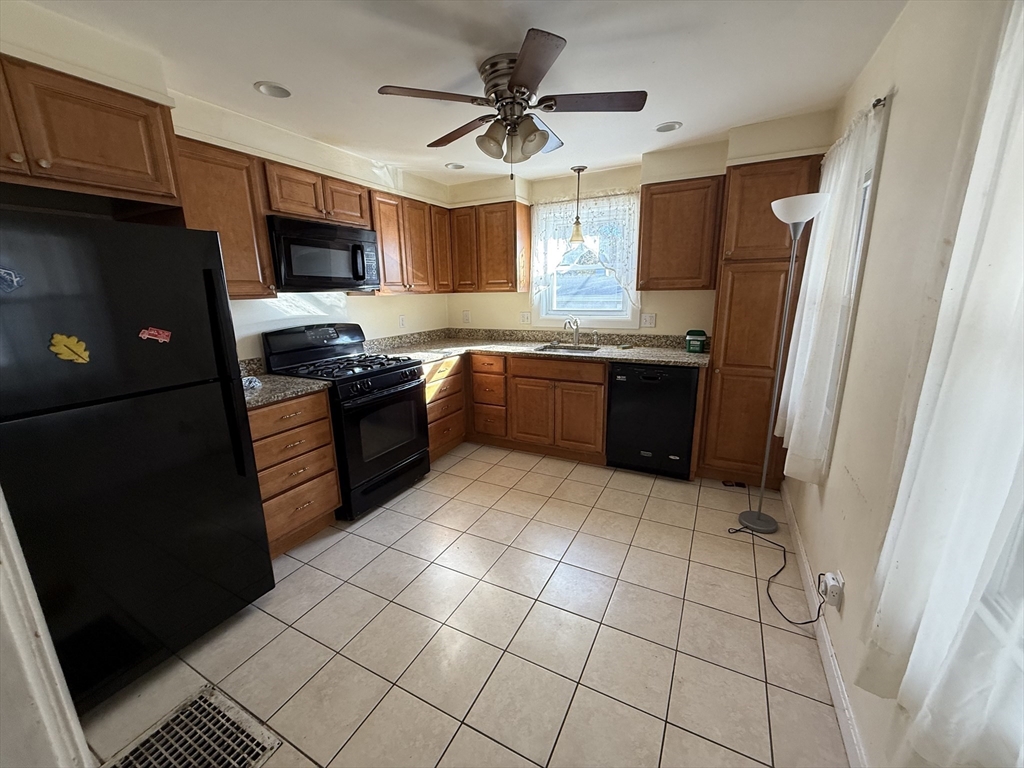100 Poplar Street Danvers, MA 01923 - Photo 22 of 24 a large kitchen with a stove a refrigerator and a sink