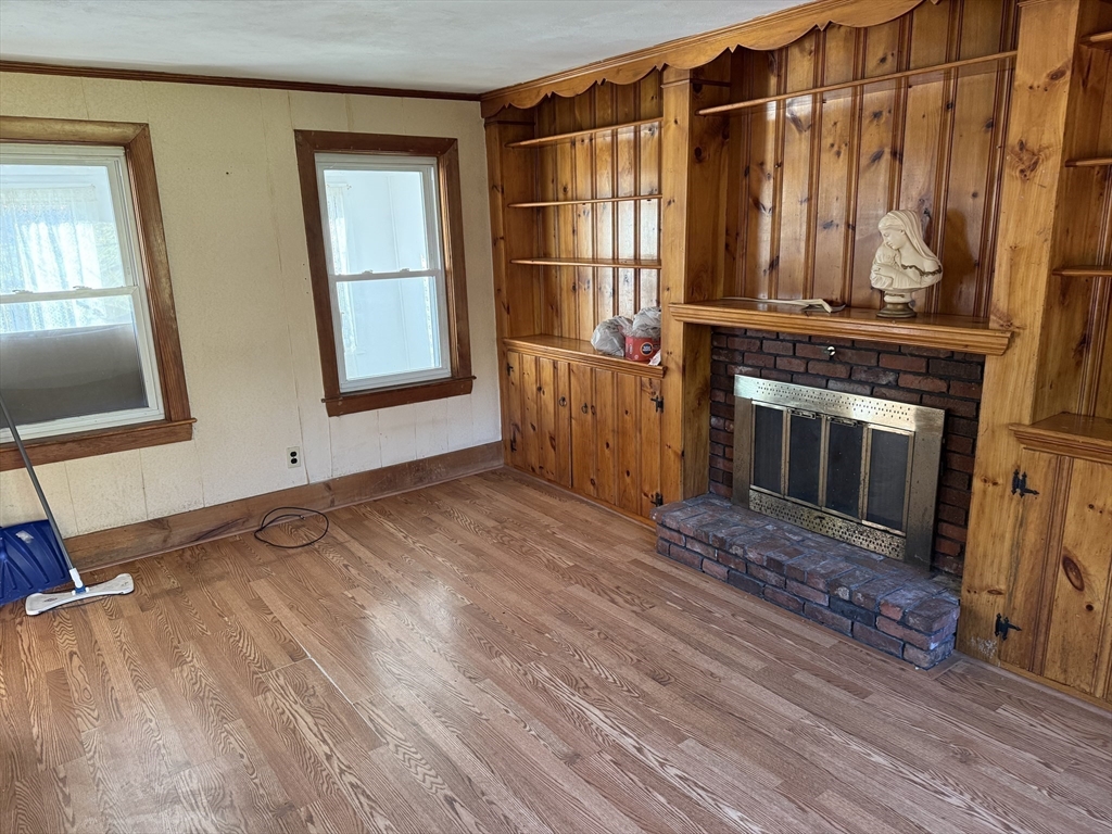 100 Poplar Street Danvers, MA 01923 - Photo 3 of 24 a view of a livingroom with wooden floor and a fireplace