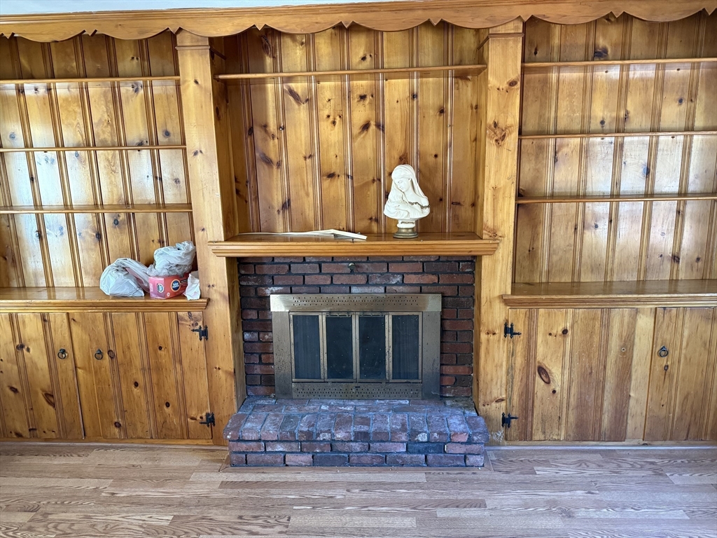 100 Poplar Street Danvers, MA 01923 - Photo 4 of 24 a living room with a fireplace furniture and a window