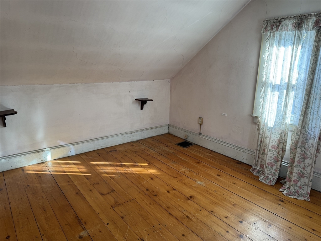 100 Poplar Street Danvers, MA 01923 - Photo 7 of 24 a view of empty room with window and wooden floor