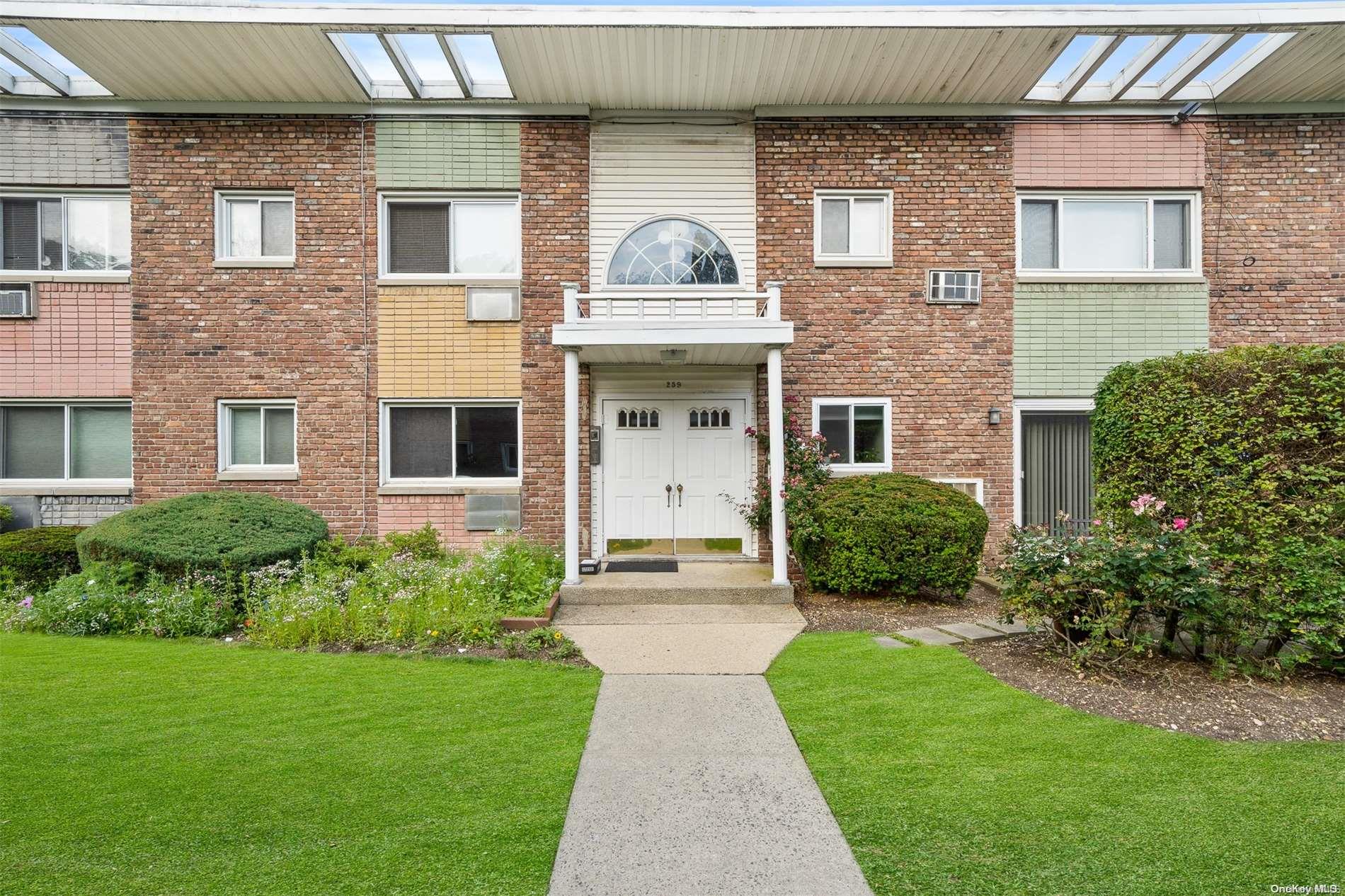 259 North Newbridge Road, Unit 2A Levittown, NY 11756 - Photo 1 of 1 a front view of a house with garden