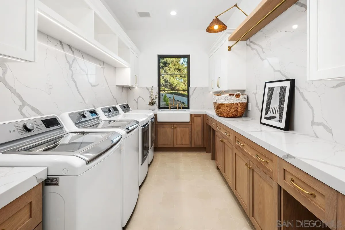 6691-93 Camino Saucito Rancho Santa Fe, CA 92067 - Photo 27 of 55 a kitchen with a sink a stove and cabinets