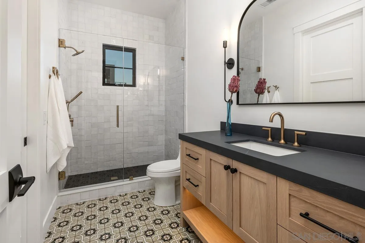6691-93 Camino Saucito Rancho Santa Fe, CA 92067 - Photo 51 of 55 a bathroom with a sink a toilet a shower and a mirror