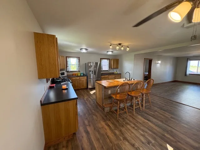 a living room with furniture a dining table and a chandelier