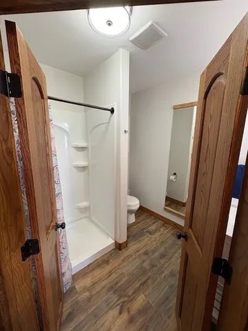 a view of a bathroom with a tub and shower